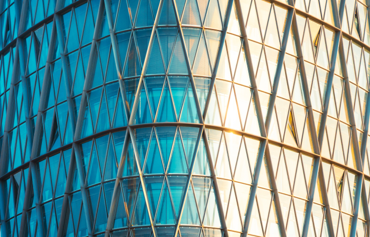 Abstracted curved building with the sun shining brightly on one side