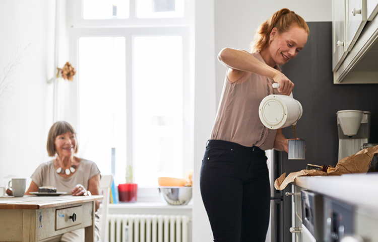 Adult woman taking care of elderly mother